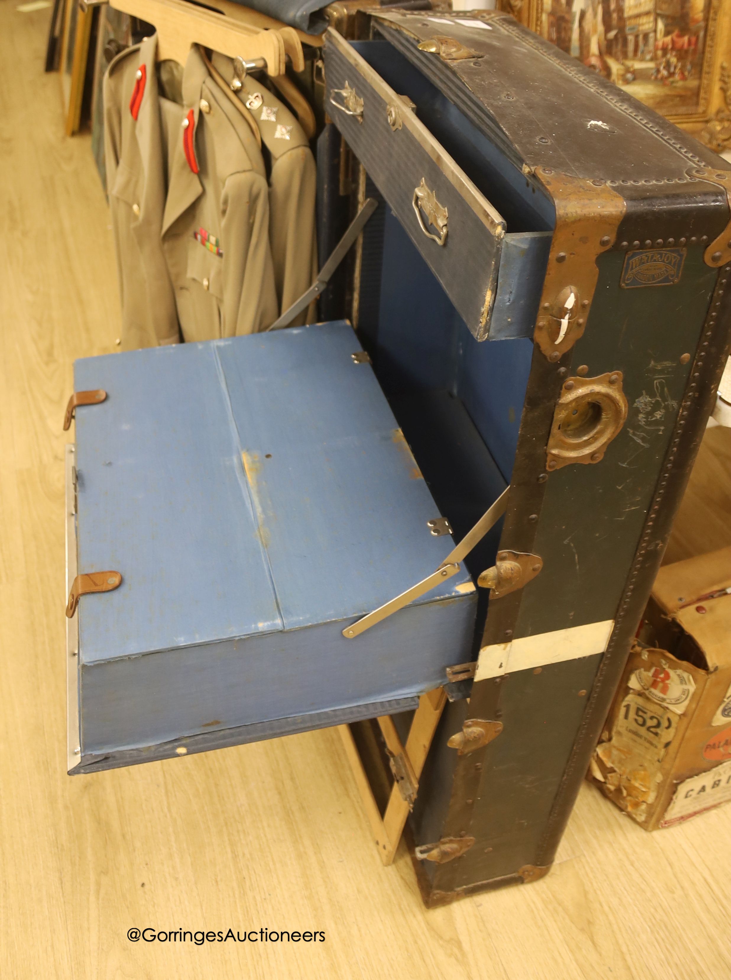 Three Khaki uniforms, one jacket without trousers, contained within a cabin trunk